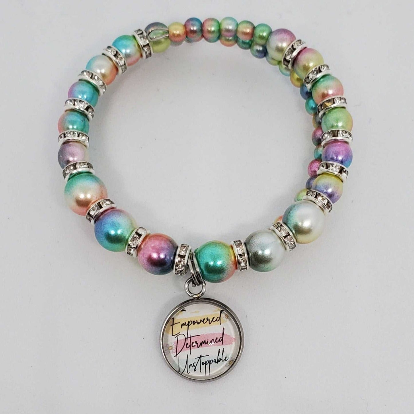 Colorful ombre acrylic pearl charm bracelet for kids with rhinestone spacers and motivational "Empowered, Determined, Unstoppable" charm.