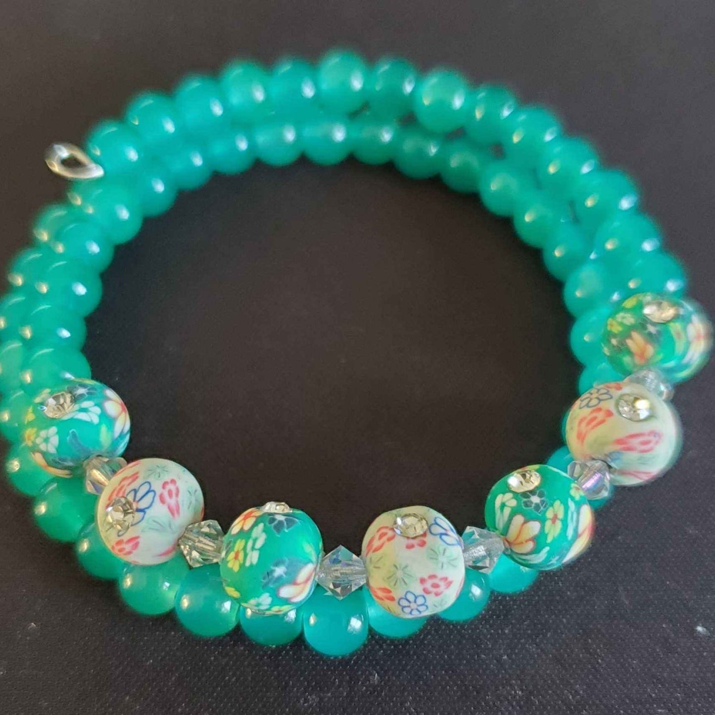 Floral beaded bracelet with polymer rhinestone flowers and Austrian crystals on flexible memory wire