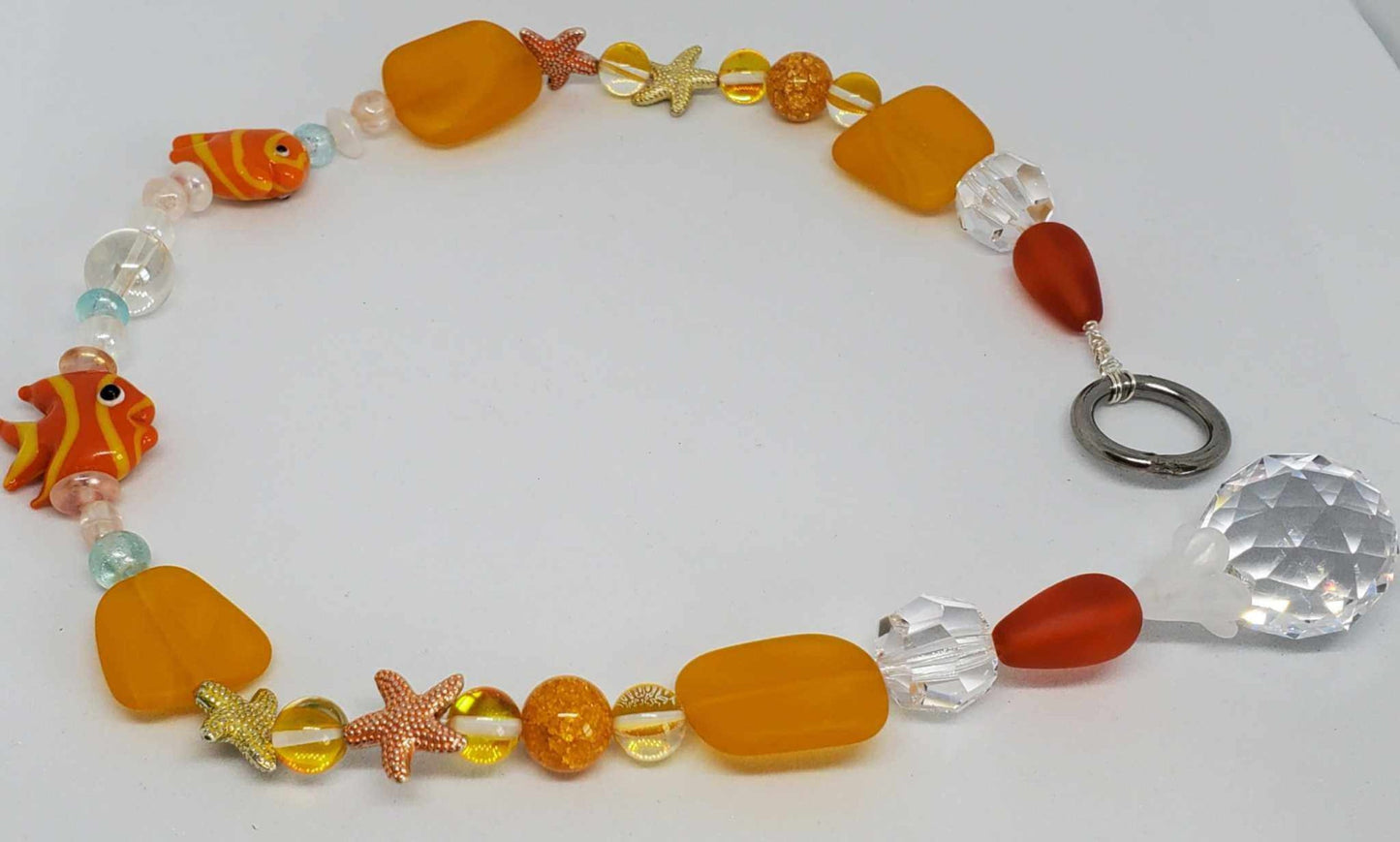 Crystal Suncatcher with aquatic-themed beads including starfish, fish, sea glass, and a faceted crystal pendant