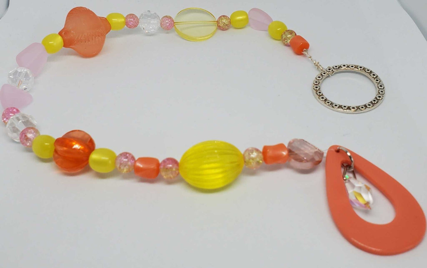 Colorful crystal suncatcher with vintage-inspired Lucite and glass beads hanging in sunlight