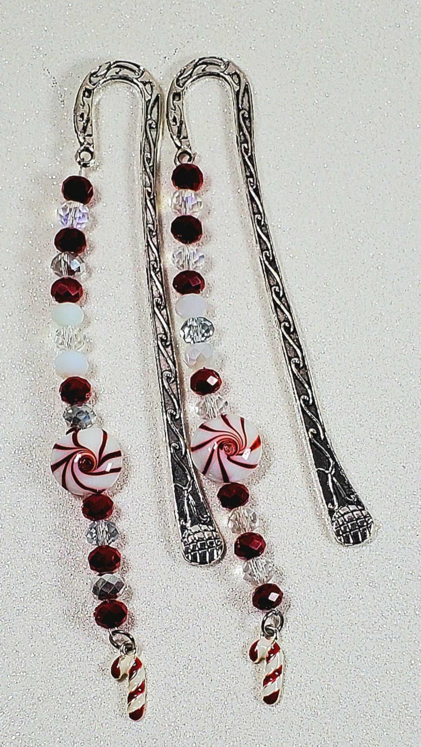 Candy Cane Bookmark with metal shepherd hook, red and white beads, peppermint candy design, and candy cane charm for holiday reading