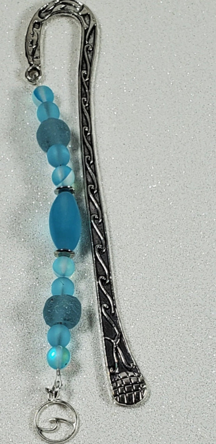 Ocean-inspired metal bookmark with blue sea glass beads and wave charm
