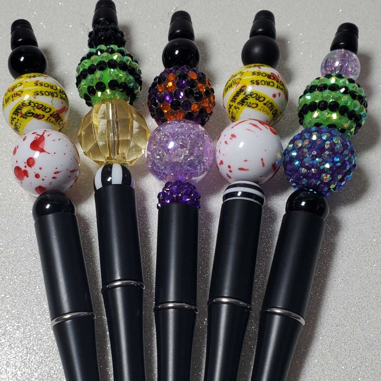 Halloween-themed decorative pens with colorful acrylic gumball beads and sleek black ballpoint tips.