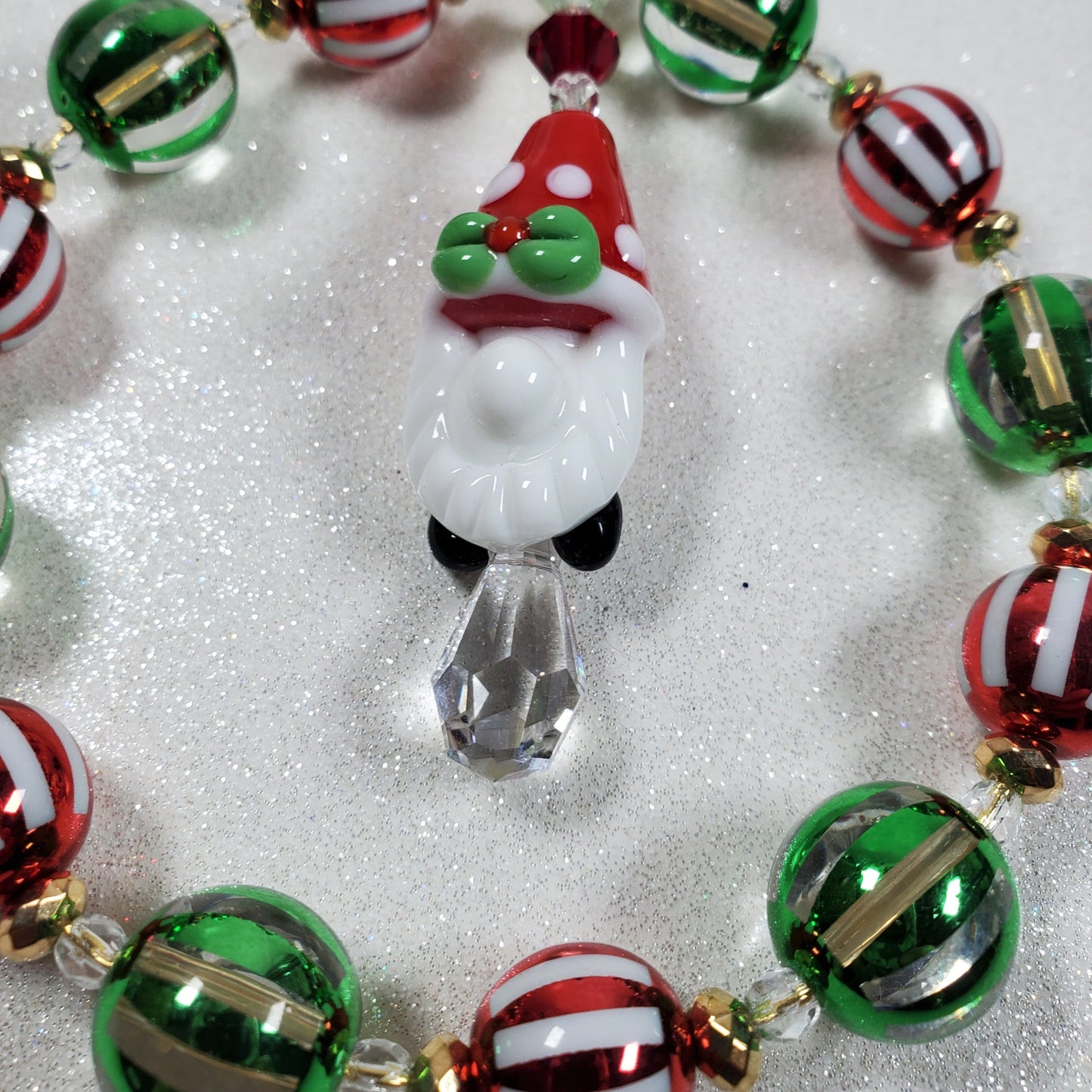 Christmas-themed beaded bracelet with a reindeer charm on a white background