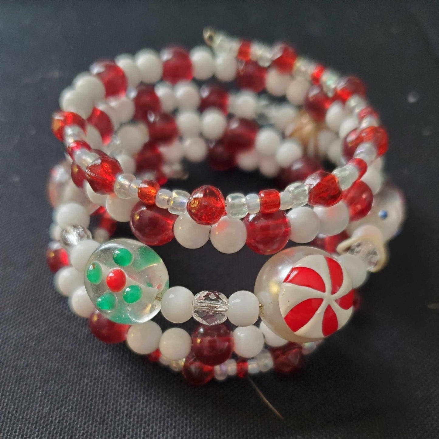 Festive lampwork cuff bracelet with red, white, and green beads for holiday style