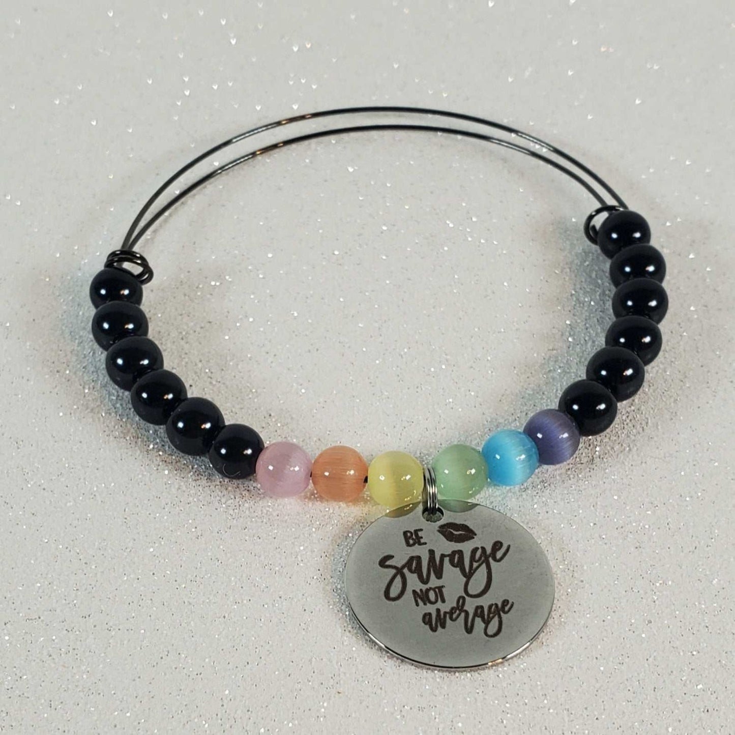 Gemstone Bracelet with Cat’s Eye beads, colorful accents, and "Be Savage Not Average" charm on flexible wire bangle