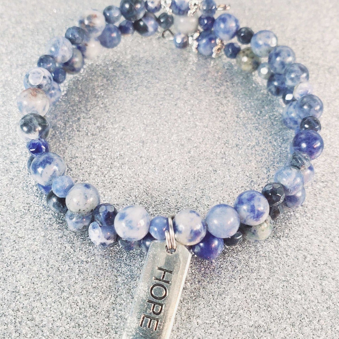 Blue gemstone bracelet with HOPE engraved pewter charm on adjustable memory wire cuff