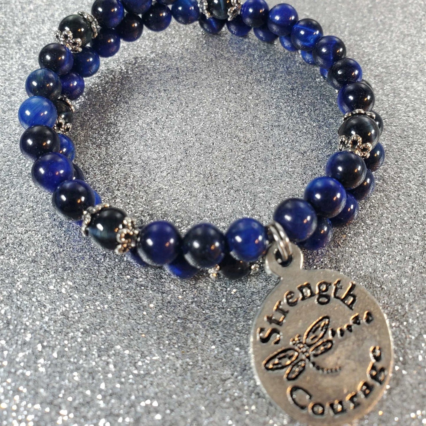 Blue gemstone bracelet with pewter beads and "Strength & Courage" charm on memory wire band
