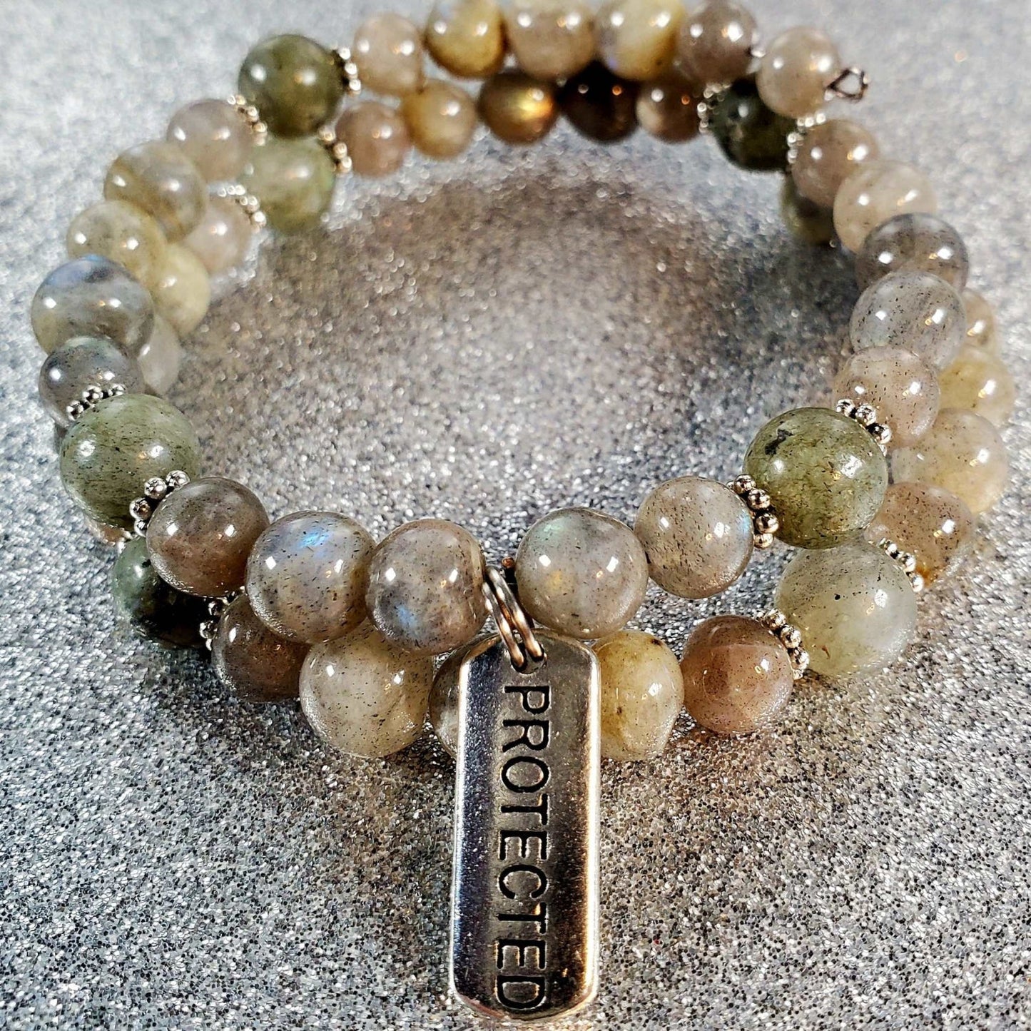 Handcrafted gemstone bracelet with protective "Protected" charm and multi-colored beads on flexible memory wire