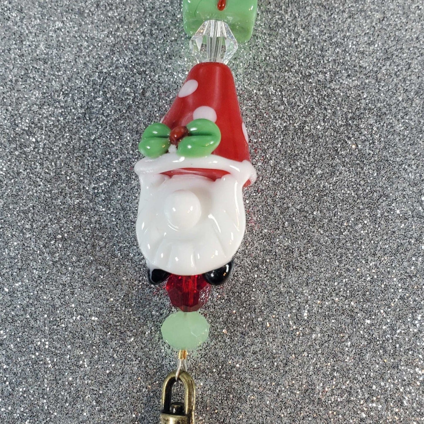 Festive holiday lanyard featuring a glass Christmas gnome, gingerbread men, crystal beads, and a brass dog clip.