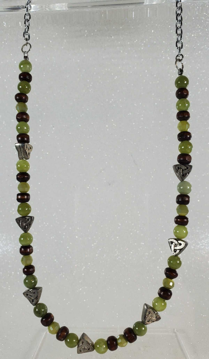Handcrafted gemstone necklace with green peridot beads, dark wood accents, and a Celtic knot design on an 18-inch chain