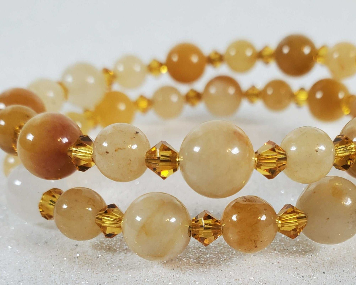 Yellow Jade gemstone bracelet with round beads and amber crystal accents on memory wire cuff design