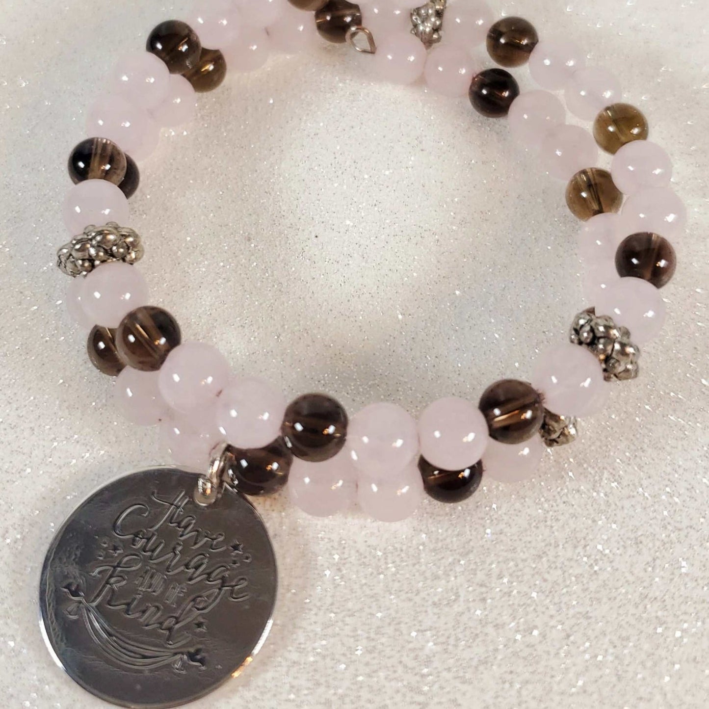 Inspirational gemstone bracelet with rose quartz, smoky quartz, and a "Have Courage Be Kind" engraved charm on memory wire cuff