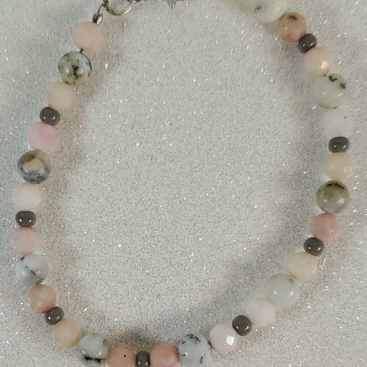Delicate gemstone bracelet with pink opal, rutilated quartz, and Czech glass beads, featuring a pewter lobster clasp