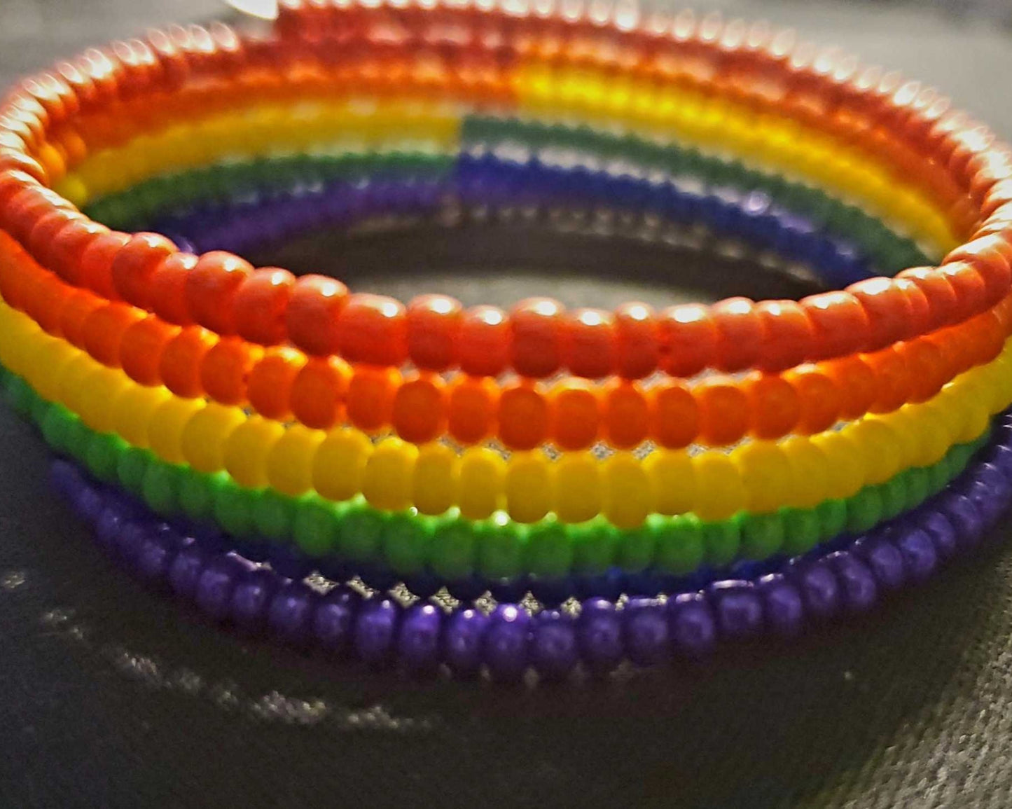 Colorful rainbow cuff bracelet with six layers of Czech glass seed beads on adjustable memory wire