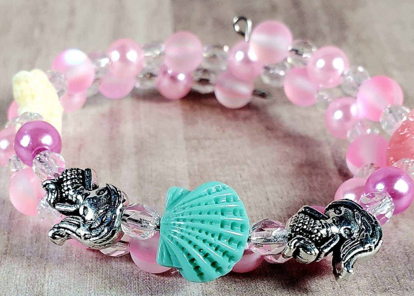 Child's mermaid bracelet with pink beads, aqua shell charm, and silver mermaid charms
