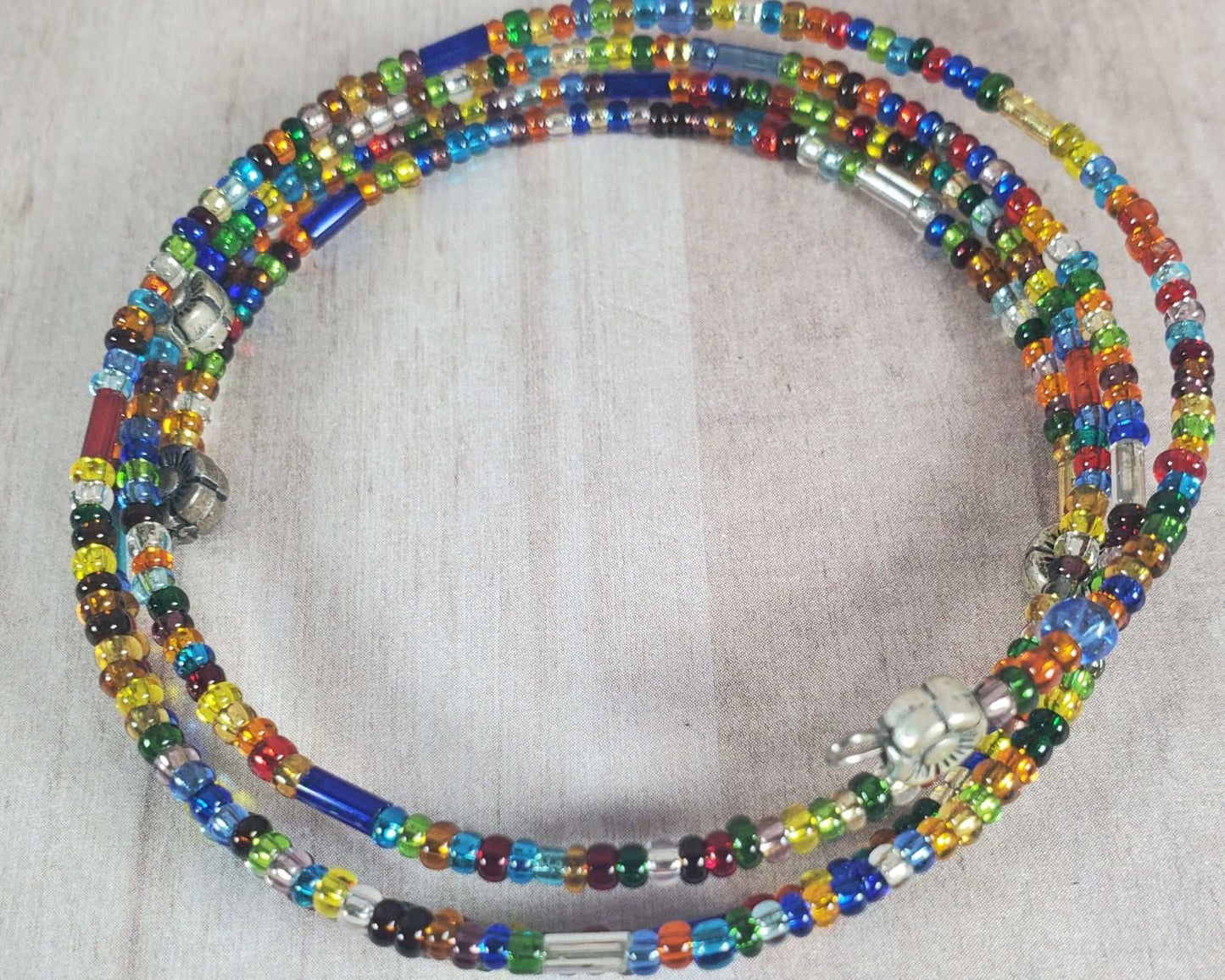 Coil Confetti Bracelet with multicolored glass beads and pewter accents on memory wire cuff