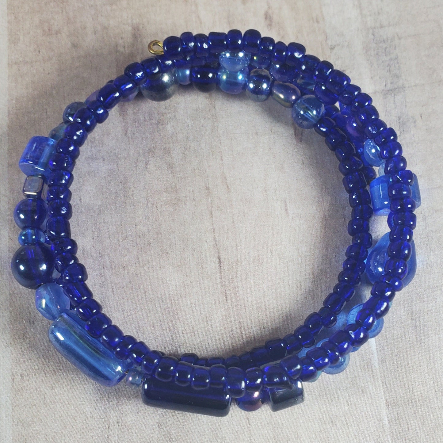 Blue beaded bracelet on a light wooden surface