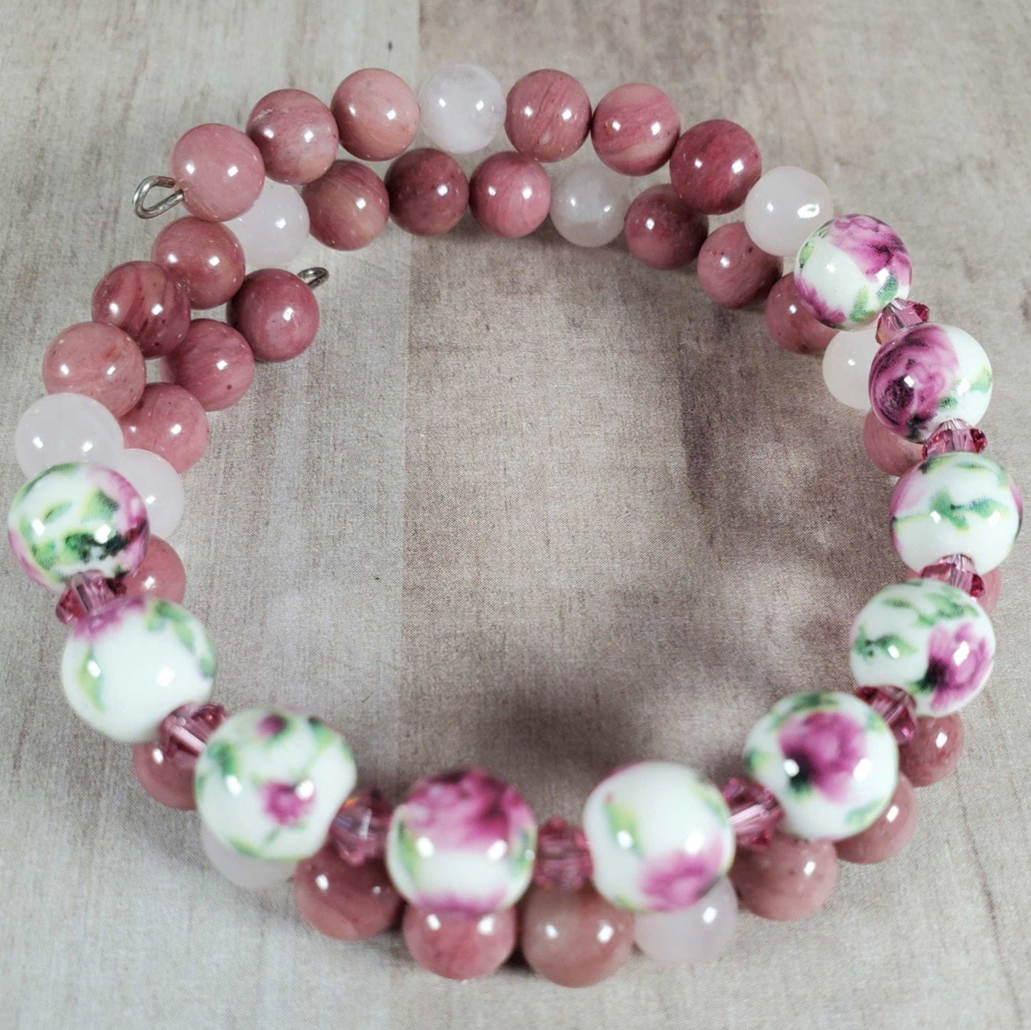 Floral bracelet with pink gemstone beads and porcelain floral beads on flexible memory wire
