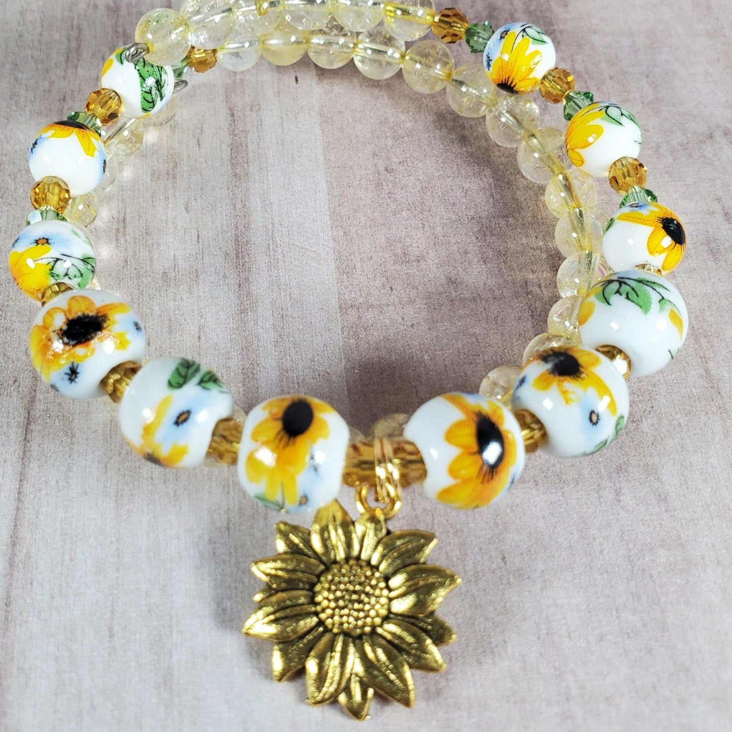 Floral bracelet with porcelain sunflower beads, citrine gemstones, Austrian crystals, and brass sunflower charm on adjustable memory wire