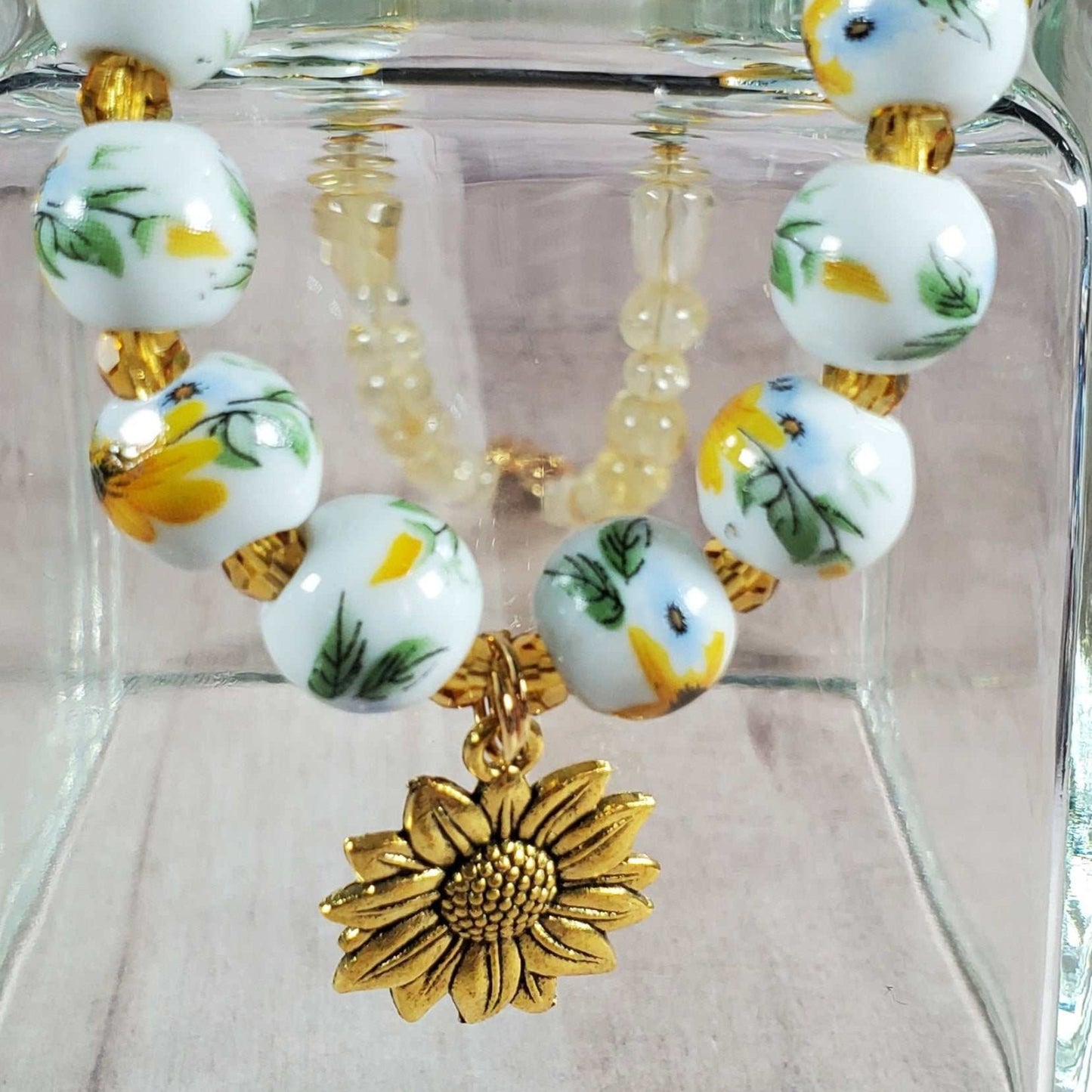 Handcrafted floral necklace with porcelain sunflower beads, citrine gemstones, and brass sunflower charm