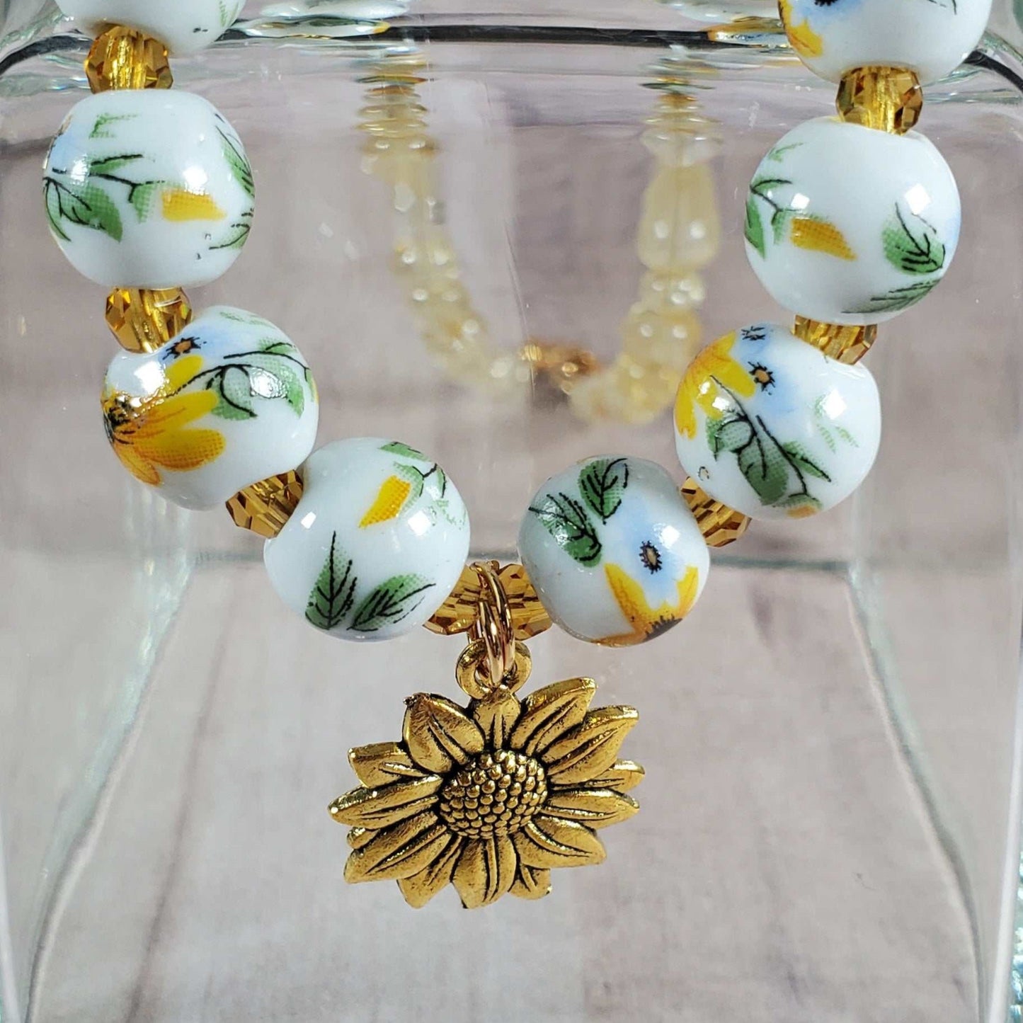 Floral necklace with porcelain sunflower beads and brass sunflower charm