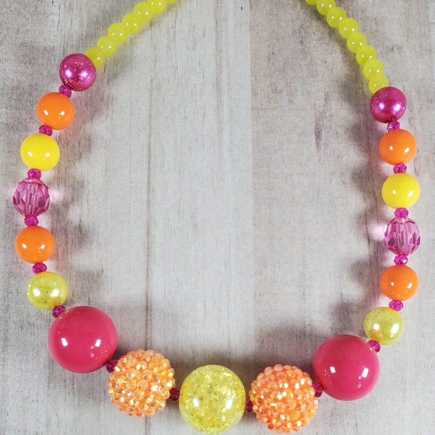 Neon Beaded Necklace with vibrant yellow, orange, and hot pink beads for summer style