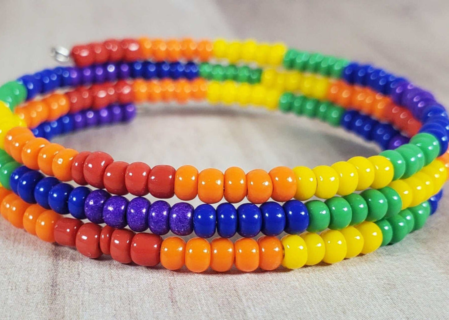 Child-sized rainbow cuff bracelet with colorful seed beads on flexible memory wire