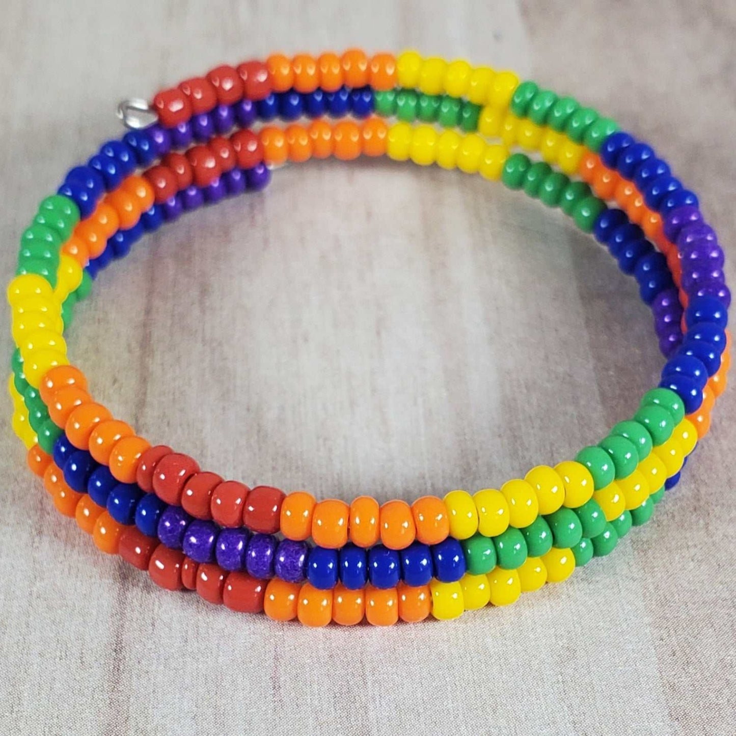 Child-sized colorful cuff bracelet with rainbow seed beads and flexible memory wire fit