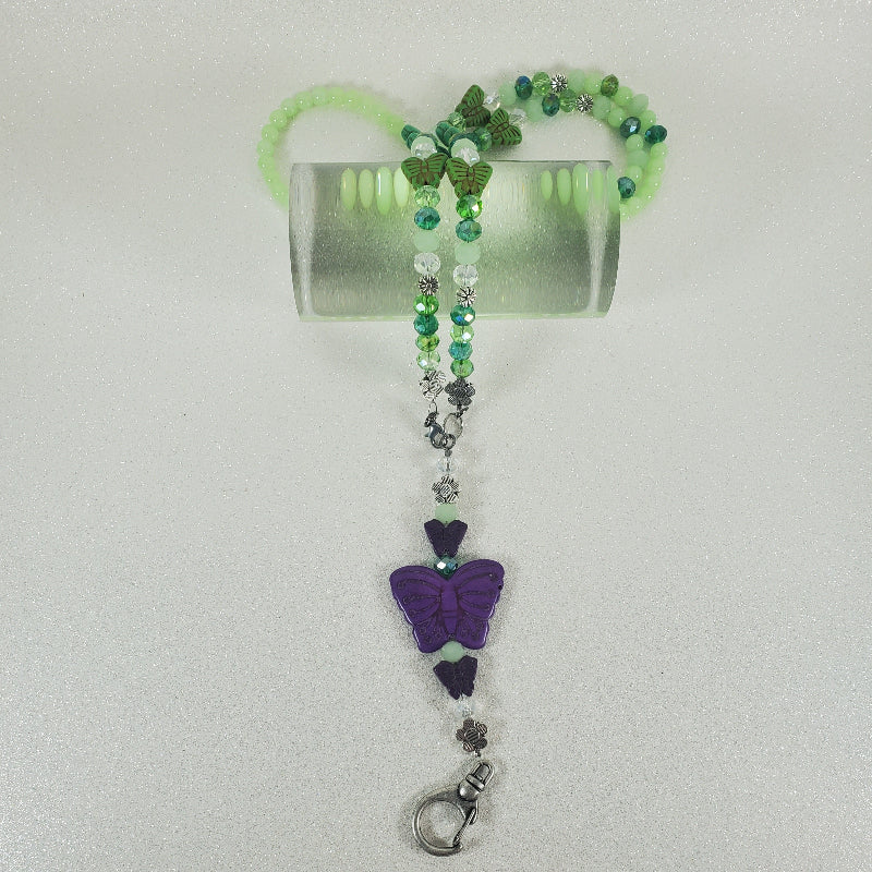 Beaded keychain with a purple butterfly charm on a white background