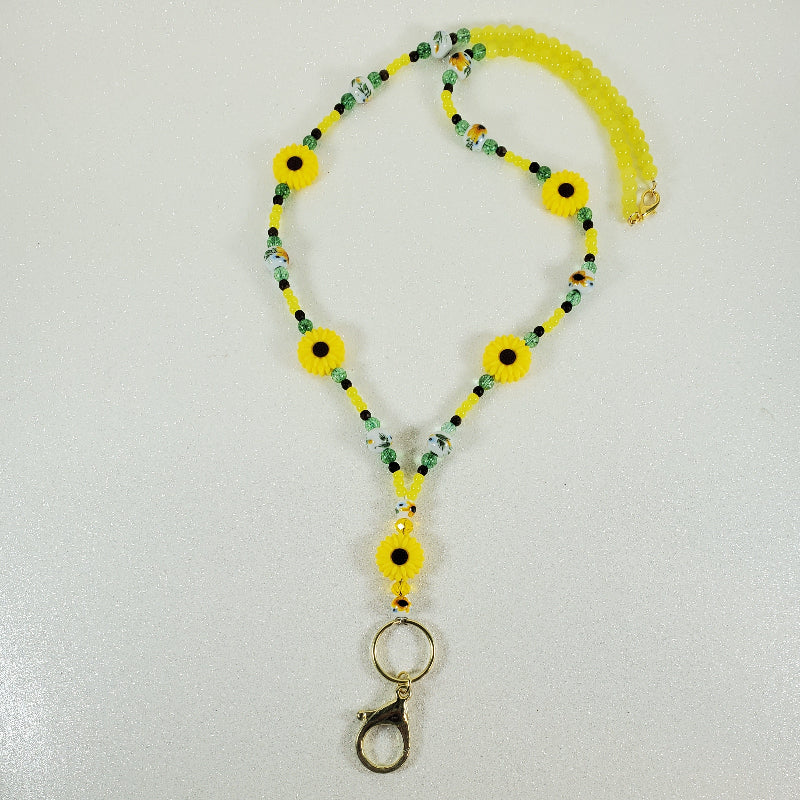 Beaded lanyard with sunflower designs on a white background
