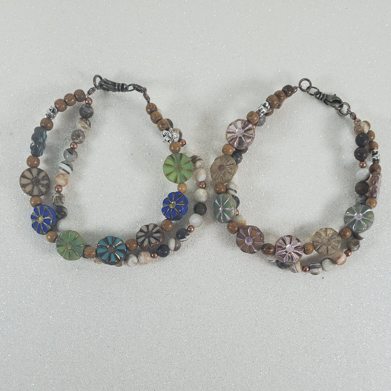 Two beaded floral bracelets on a light gray background