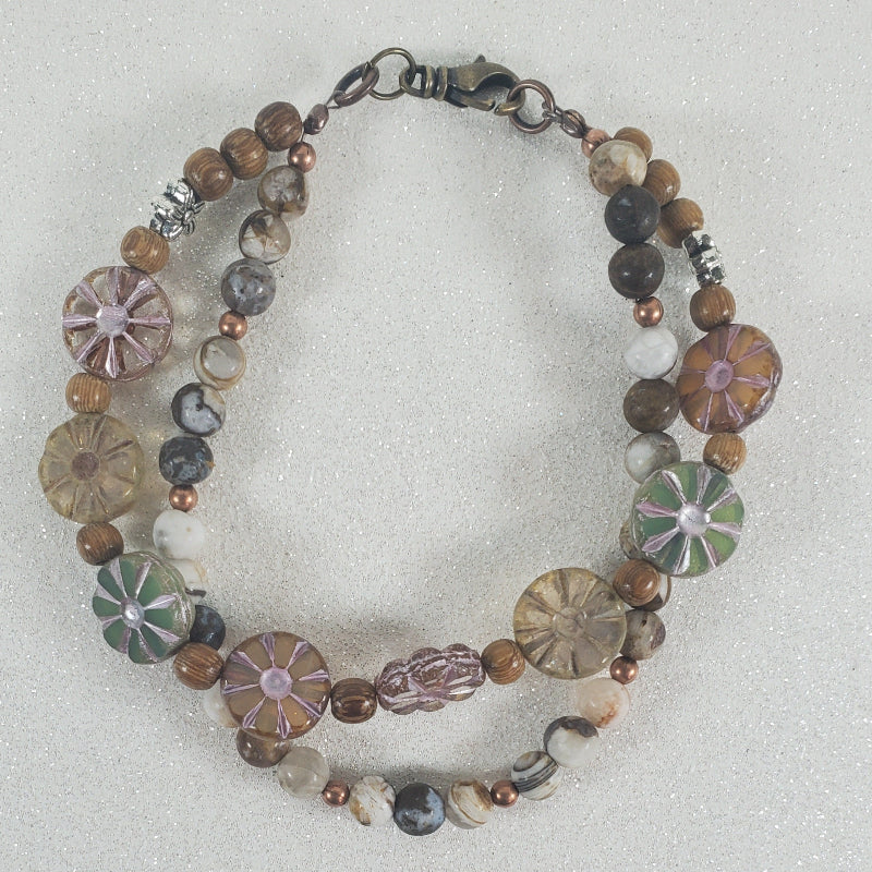 Multicolored beaded bracelet on a light gray background