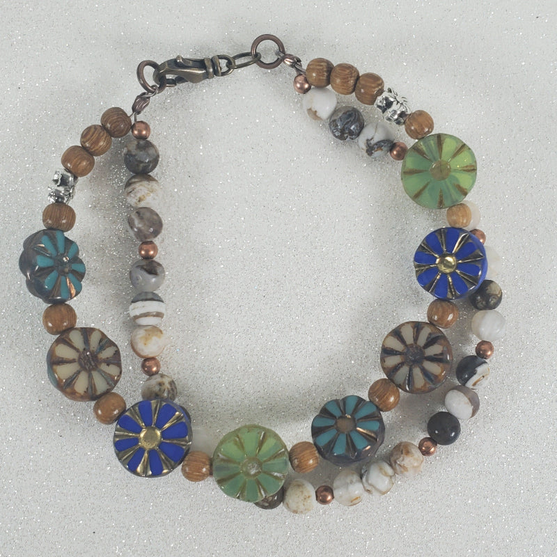 Multicolored beaded floral bracelet on a light gray background