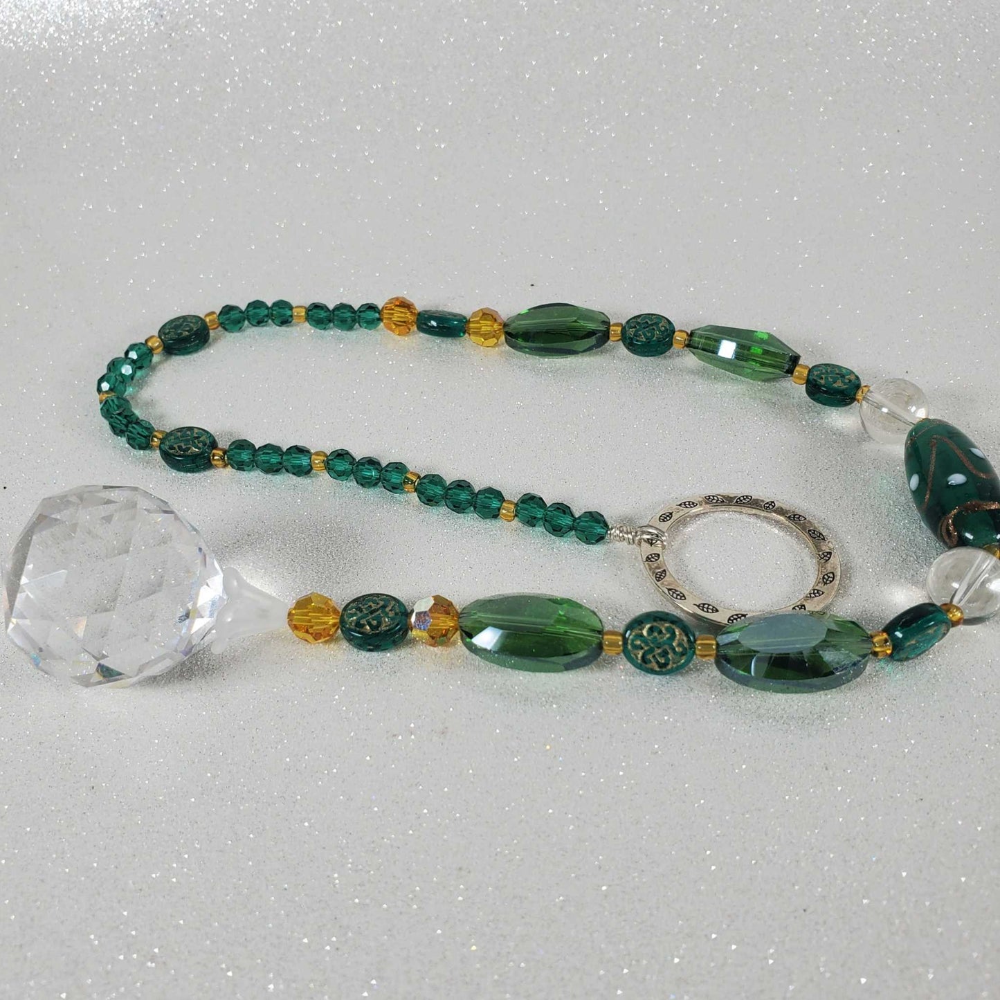 Handcrafted Celtic green crystal suncatcher with emerald beads and 20mm drop prism reflecting light