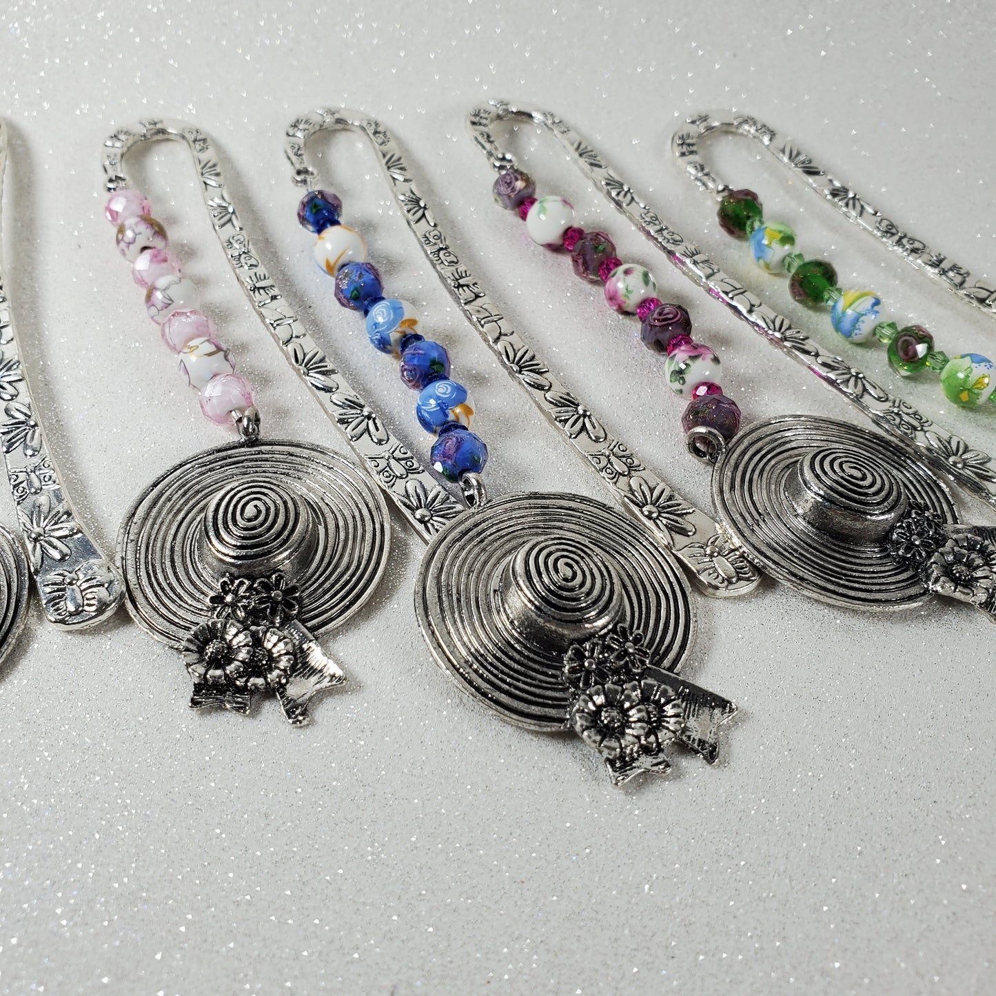 Floral themed decorative bookmarks on a textured gray background