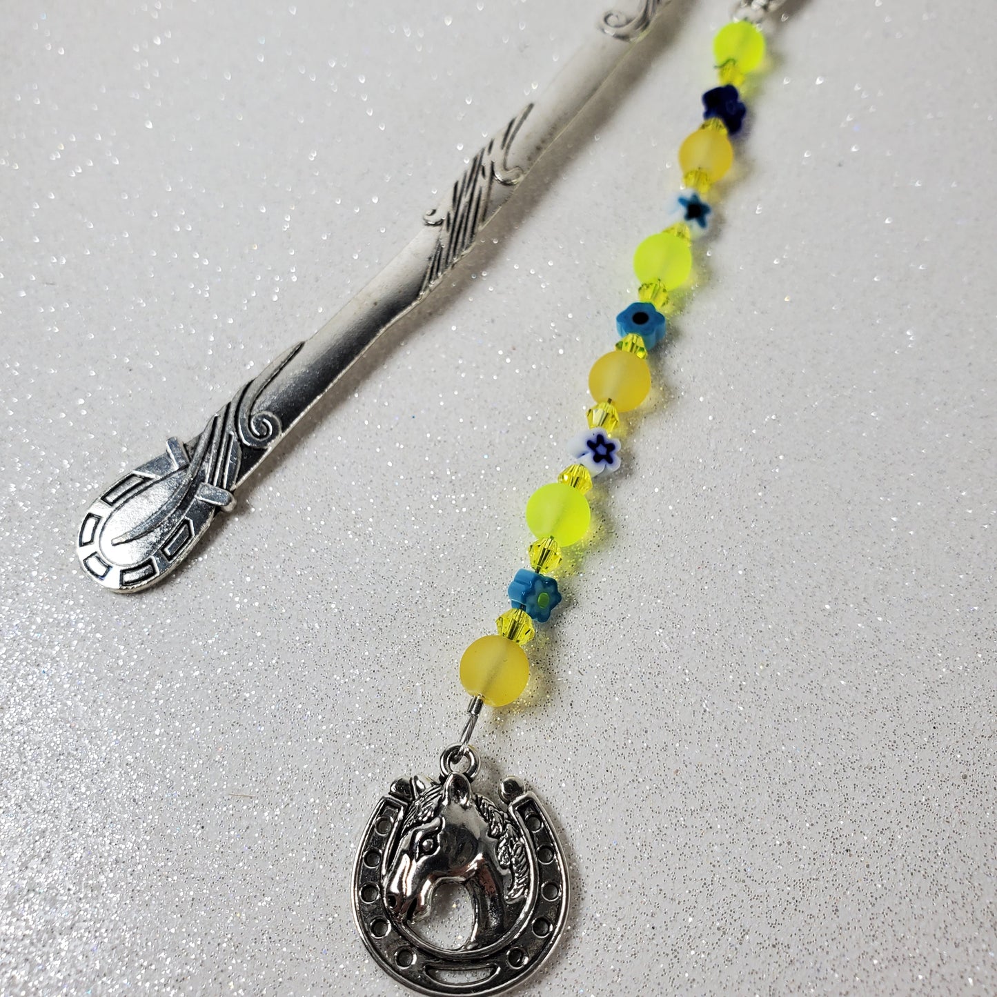 Decorative bookmark with colorful beads on a gray background