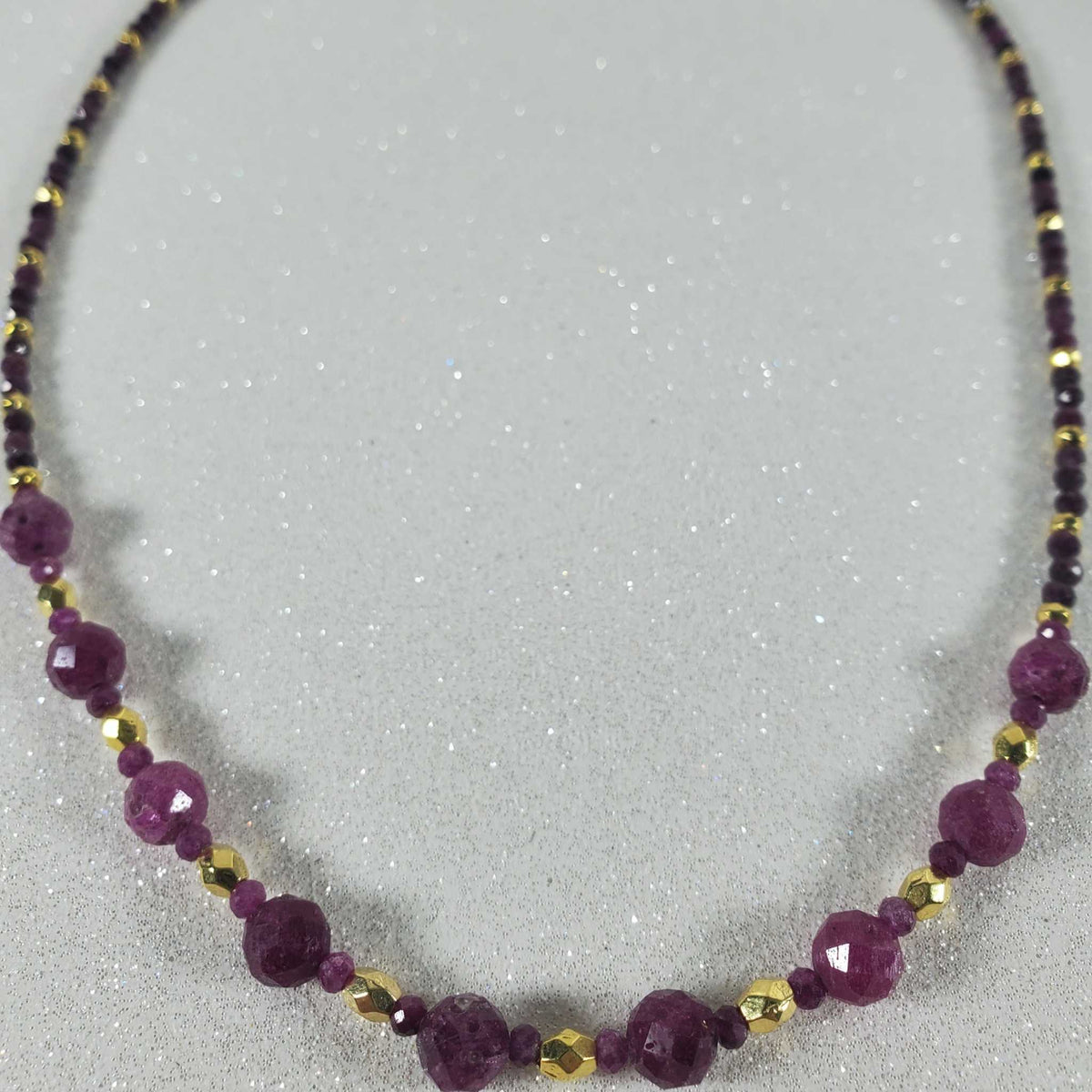 16-inch gemstone necklace with deep red ruby beads and gold hematite accents