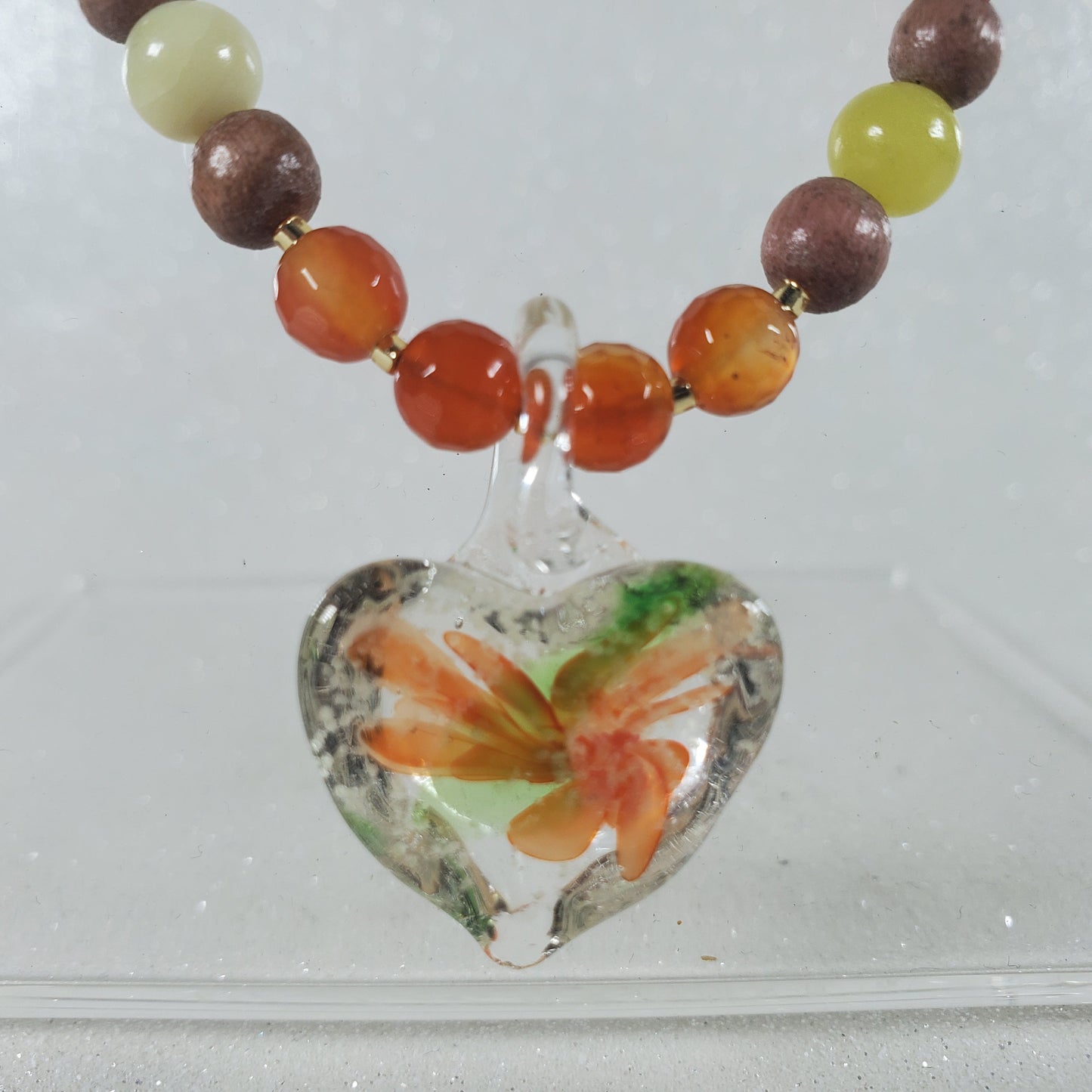 Necklace with a heart-shaped floral pendant on a white background
