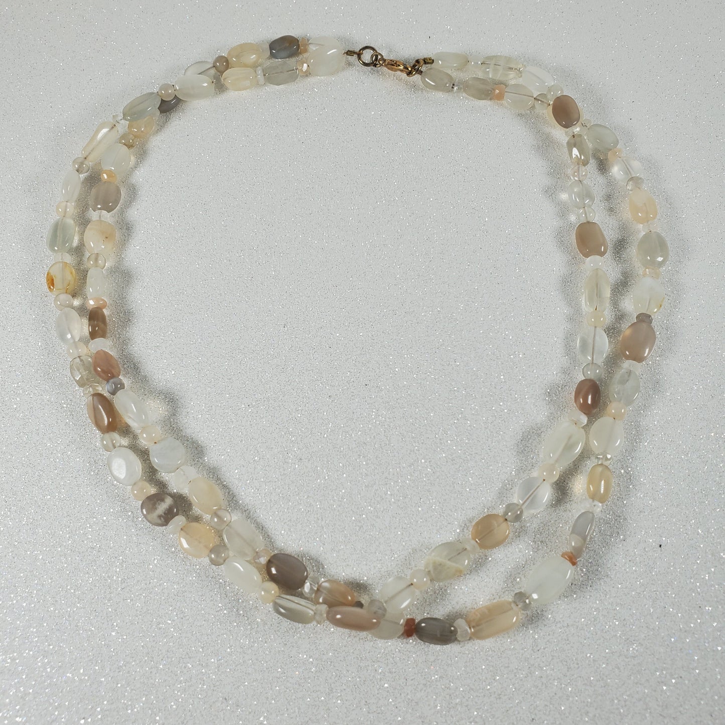 Necklace with multicolored beads on a light gray background