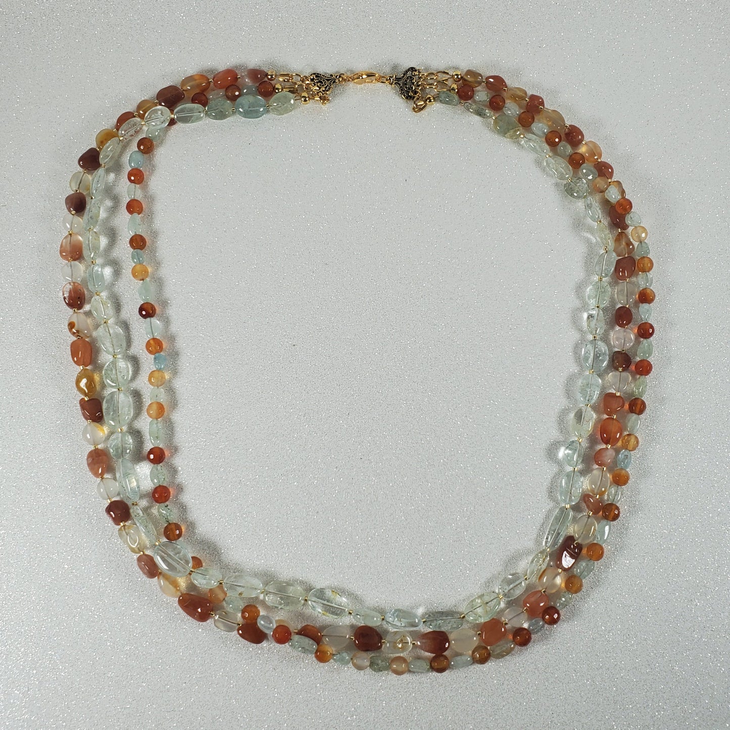 Multistrand beaded necklace on a light gray background