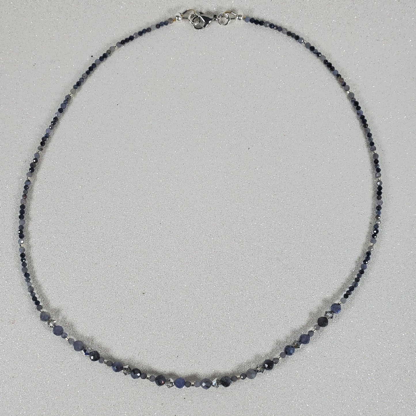 Necklace with blue beads on a light gray background