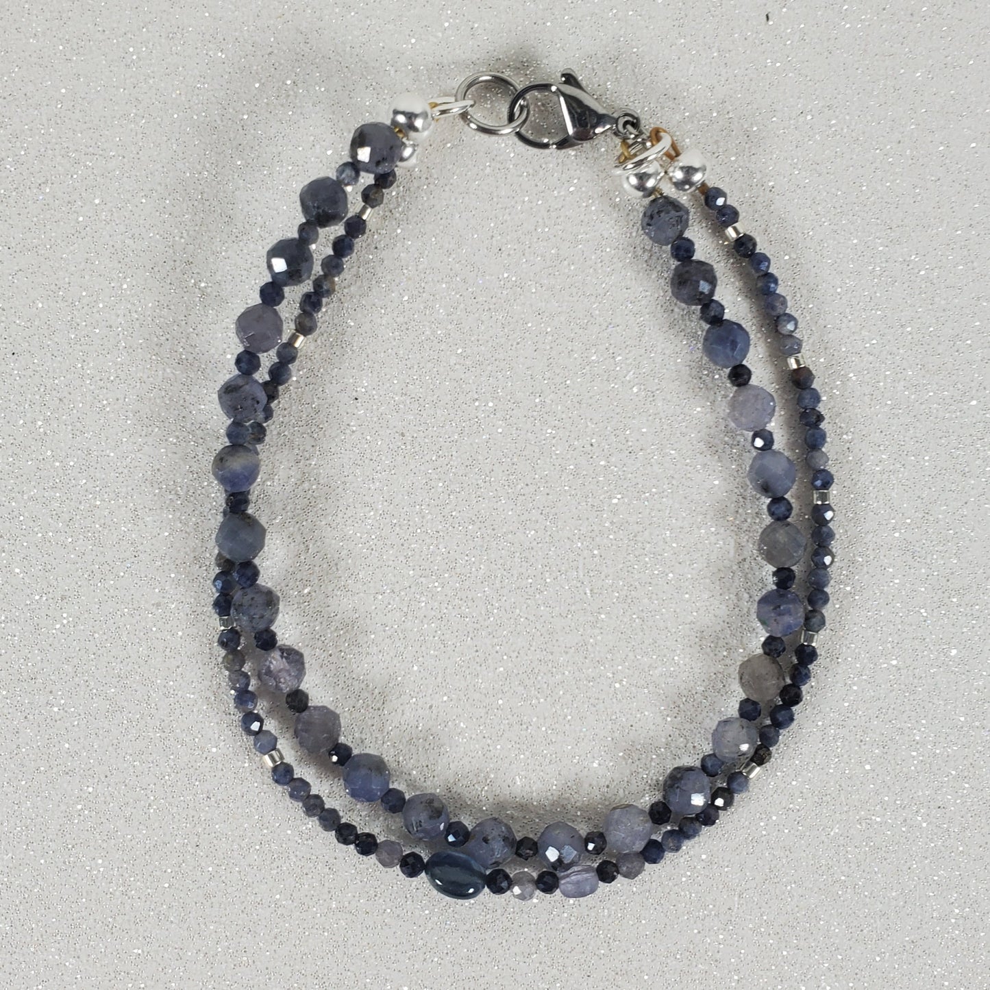 Blue beaded bracelet on a light gray background