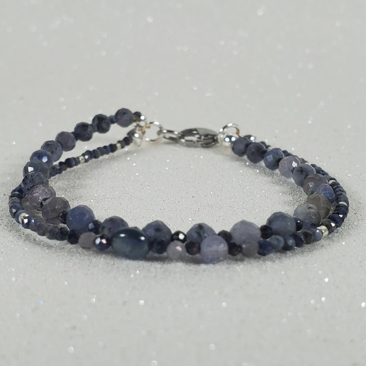 Beaded bracelet on a gray glittery background