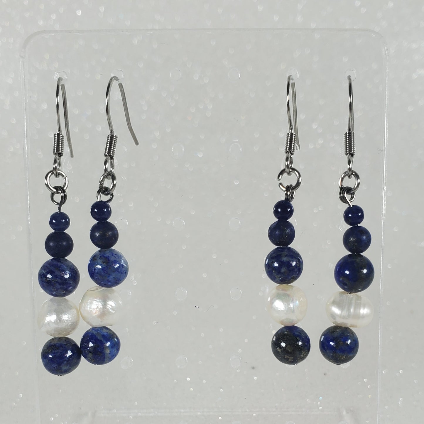 Pair of blue beaded earrings on a white background