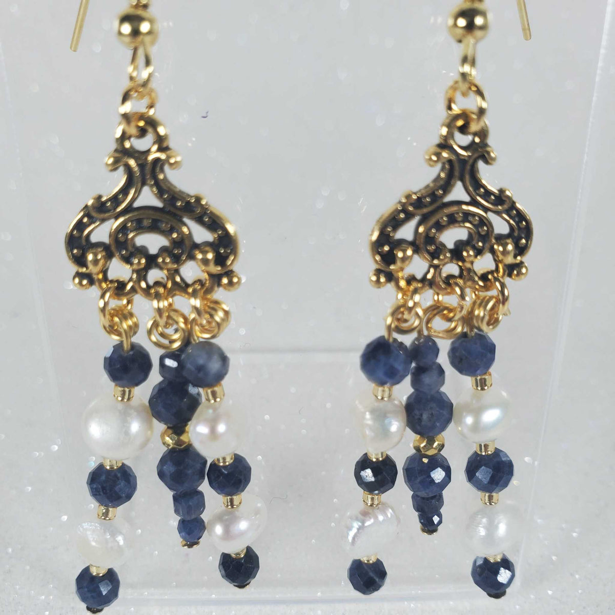 Chandelier-style Gemstone Earrings: Sapphire with gold-tone filigree, dangling dark blue faceted beads and white pearls.