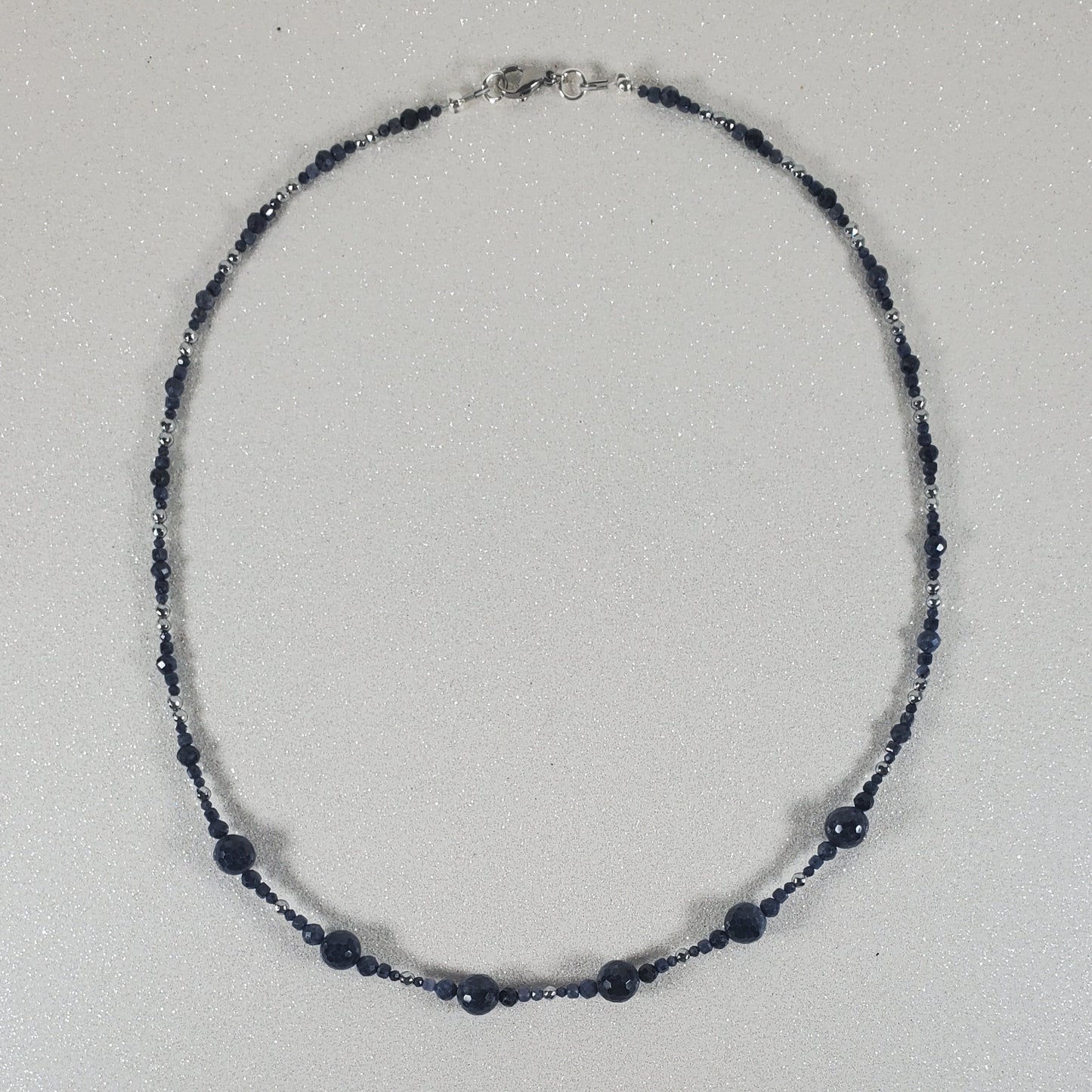 Necklace with blue beads on a white background