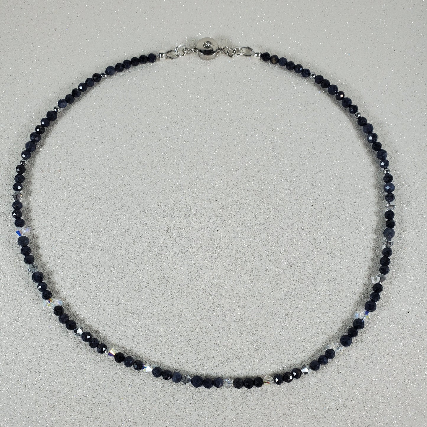 Necklace with Sapphire beads on a light gray background