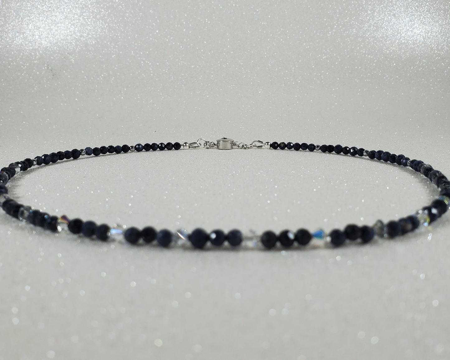 Necklace with blue beads on a gray background
