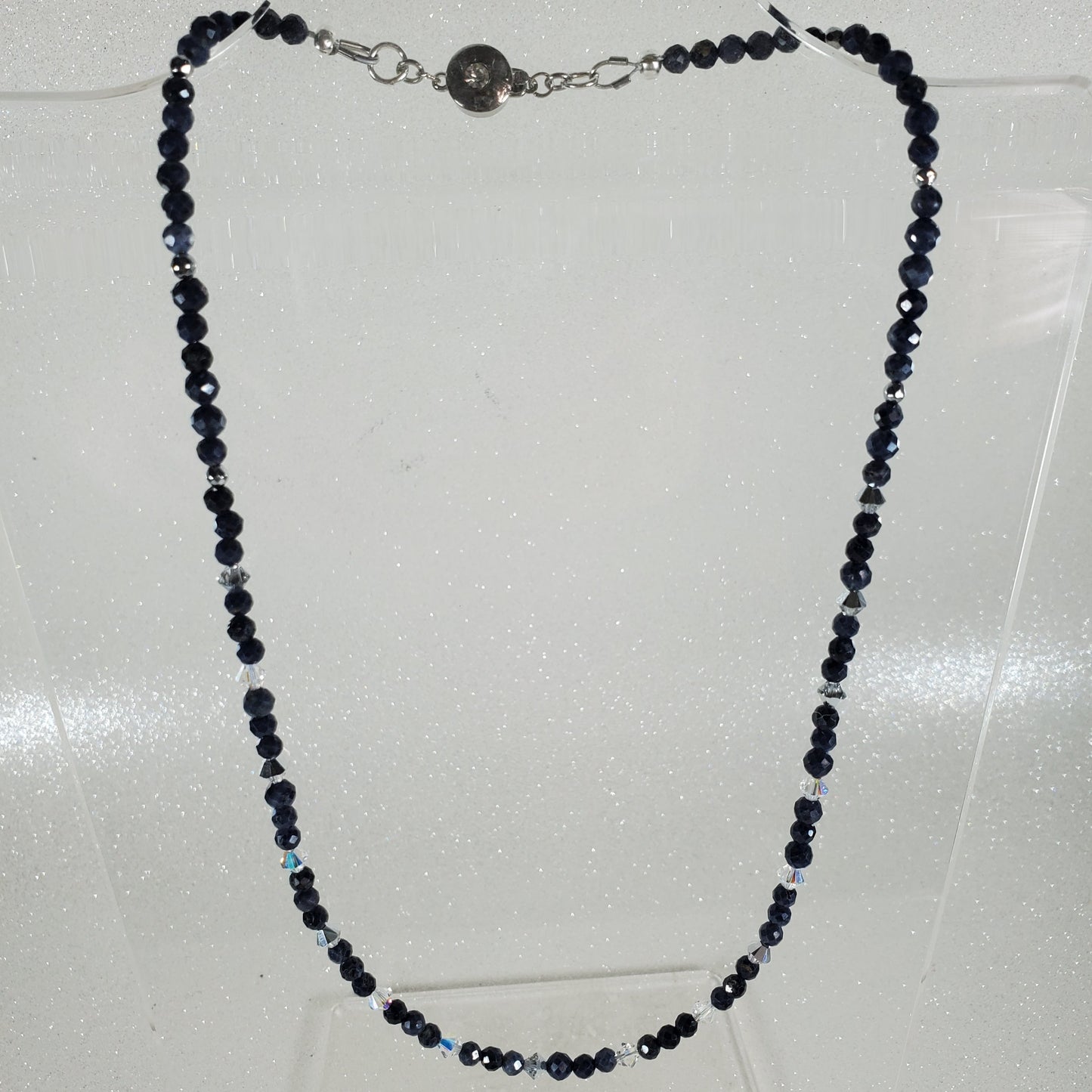 Necklace with blue beads on a light gray background